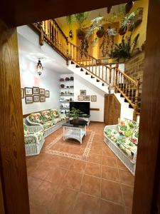 a living room with couches and a staircase at Casa Loli y Las in Agaete +27 photos