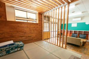 an empty room with wood paneling and a waiting room at まるもりビレッジ in Wada