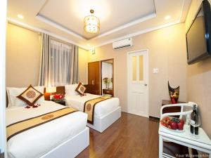 Postel nebo postele na pokoji v ubytování ACE Hotel - Bến Thành
