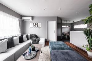 a living room with a couch and a table at The Serenity in Obihiro +45 photos