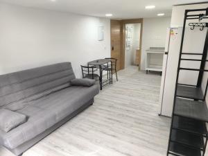 a living room with a couch and a table at Holidays Domus Papokkio in Igualada