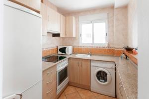 a kitchen with a washing machine and a washer at Chalet Llamàntol in Oliva