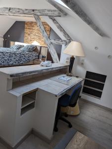 a bedroom with a desk with a bed and a desk at Le Bleuet in Spay +9 photos