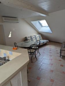 a living room with a couch and a table and chairs at Le Bleuet in Spay