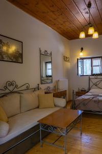 a living room with a couch and a table at Tholos in Áno Dholianá +14 photos