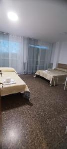 En eller flere senge i et værelse på Villa Olivares