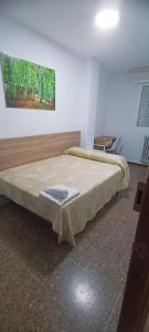 En eller flere senge i et værelse på Villa Olivares