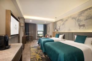 Ein Bett oder Betten in einem Zimmer der Unterkunft Mehood Lestie, Zhangbaliu Road, Xi'an High-tech Zone