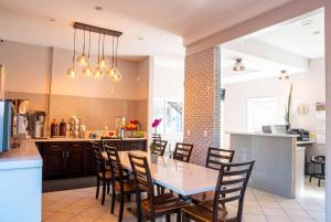 a kitchen and dining room with a table and chairs at Ramada by Wyndham Redondo Beach in Redondo Beach