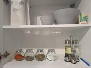 a shelf with spices and other items in a refrigerator at R&R studio in Cluj-Napoca