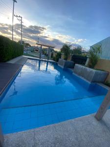 a swimming pool with blue tiles on the ground at Paradise Room in Las Piñas City in Manila