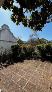 a stone walkway with bushes and a building at Retro City Center Gem by ARPA Hospitalities in Stellenbosch