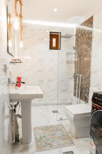 a bathroom with a sink and a shower and a toilet at Barlos Noyob in Bukhara