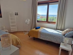 Ένα ή περισσότερα κρεβάτια σε δωμάτιο στο Figueira Family Apartment