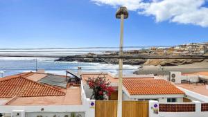 a view of the ocean and houses with a street light at Harmony Beach Views Home with Terrace in Telde