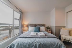 a bedroom with a bed and a large window at Hillside Haven Perfect Getaway in Lake Tekapo in Lake Tekapo