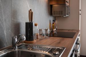 a kitchen with a sink and a counter top with a counter top at Hotel Wirt Weissau in Oberweißau +84 photos