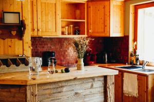 a kitchen with wooden cabinets and a wooden counter top at Joubarbe Violette by Lodji in Saint-Martin-de-Belleville