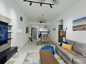 a living room with a couch and a table at D'bey Melaka Homestay in Bukit Baru