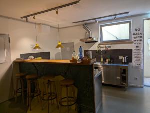 a kitchen with a bar with stools in it at Backpackers St. Pauli in Hamburg