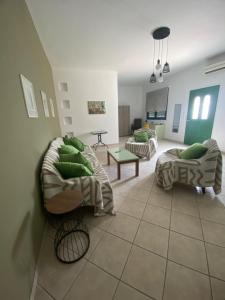 a living room with two couches and a table at Stella's House in Mytilinioí +8 photos