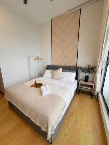 a bedroom with a bed with two towels on it at Cozy Beachfront Seaview with 2 CarParks FOC Netflix Access and YouTube Premium 3Beds3Bath 6-11pax by Minshuku in Johor Bahru