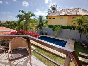 a patio with a chair and a swimming pool at Panorama Cumbuco in Cumbuco
