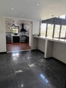 a kitchen with a large tile floor in a house at La escondida in Ramallo