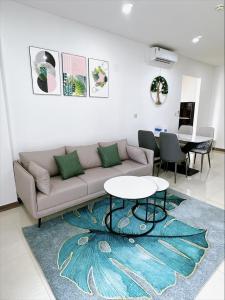 a living room with a couch and a table at The RIO Ha Do Home City in Ho Chi Minh City +16 photos
