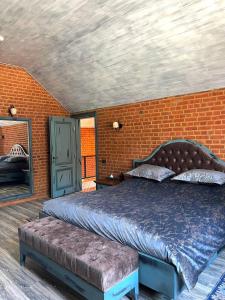 a bedroom with a bed and a brick wall at Dad Residence in Lankaran