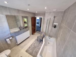 a bathroom with a shower and a toilet and a sink at Spacious & Upmarket 2 Bedroom Detached Bungalow in Boston in Boston +34 photos