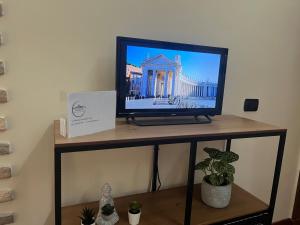 a flat screen tv sitting on a stand at Vicolo 35 in Rome