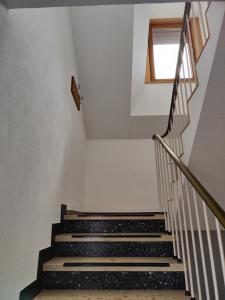 a set of stairs with a window in a building at Gemütliches, ruhiges Zimmer mit eigenem Bad in Werther +6 photos