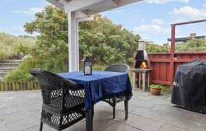a table with a blue table cloth on a patio at Holiday Home Fanø 59 in Fanø
