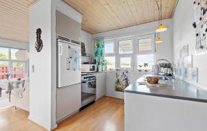 a kitchen with white appliances and a counter top at Holiday Home Fanø 59 in Fanø +8 photos
