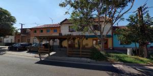 a building with a shelter on the side of a street at Apartman Romana in Poštorná