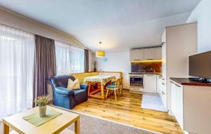 a kitchen and living room with a couch and a table at Schoene Ferienwohnung in Kirchberg in Tirol
