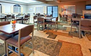 a restaurant with tables and chairs in a room at Blue Way Inn Eagan Extended Stay in Eagan