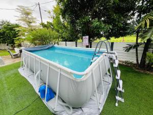 a swimming pool with at PULAI FIELD AA HOMESTAY in Kangar