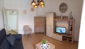 a living room with a couch and a tv at My FAMILY INTERO APPARTAMENTO CON PARCHEGGIO PRIVATO in Potenza