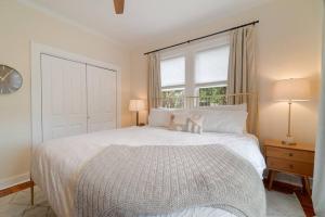 a bedroom with a white bed and a window at Relax in Hacienda de Paradise in SoSo West Palm Beach in Cloud Lake