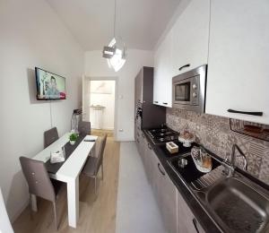 a kitchen with a sink and a counter top at My FAMILY INTERO APPARTAMENTO CON PARCHEGGIO PRIVATO in Potenza