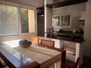 a kitchen with a table with a bowl of fruit on it at Bosque de Ciruelos in Carilo