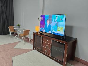a flat screen tv sitting on top of a dresser at Nathamon House Hatyai in Hat Yai