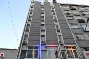 a tall apartment building with a purple door and windows at Grand Bona Sera Hotel in Istanbul
