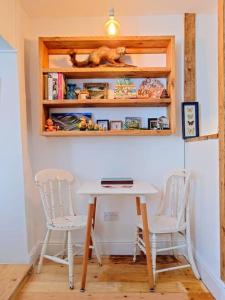 a table and two chairs in a room at Cosy Welsh Town Cottage in Brecon +14 photos