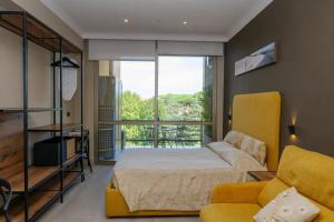 a bedroom with a bed and a yellow couch at Domus Aurelia in Rome +207 photos