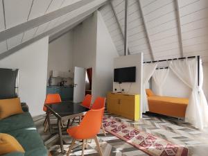 a living room with a bed and a table and chairs at Mountain Resort Gabala in Nourkyshlak
