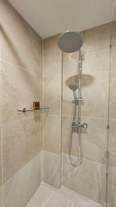 a bathroom with a shower with a glass door at Betworld Casino & Hotel in Krong Poi Pet