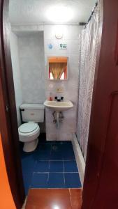 a small bathroom with a toilet and a sink at La Posada Colonial in Quito +49 photos